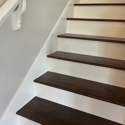 Close view of dark wood stair treads with white risers